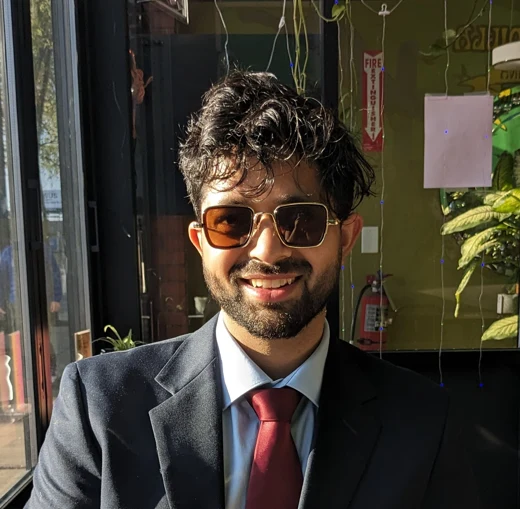 Kumar Kshitij Patel, wearing a suit and sunglasses